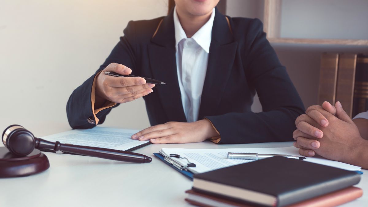 A woman at a desk with a gavel, illustrating key considerations for trust in asset inclusion.