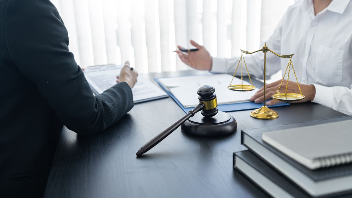 A lawyer and a client at a desk, emphasizing the critical responsibilities and common issues encountered by successor trustees.